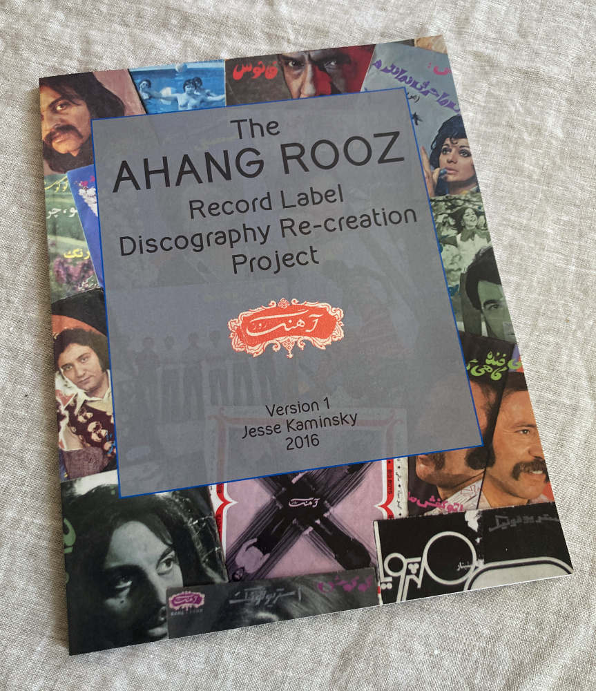 Ahang Rooz Discography Re-Creation Project This is version One: 
94 pages, magazine-sized, full color with color cover, 2016. $20<br><br> 
I’m not a librarian. I’ve never been to Iran. I don’t have any Iranian heritage and can’t speak or read Farsi. In 2006, I happened to find a record by the singer Aghassi in a local thrift store that opened the door to an amazing world for me. At the time I was regularly buying any inexpensive records I could find that I didn’t already recognize. I had just started producing a weekly radio show that focused on non-American music made for domestic markets around the world and I constantly needed more songs to fill up the 2 hour show every week. Record-buying was an act of discovery and I pushed my very limited budget to fill in shelf after shelf of highly suspect dollar bin items. The rate of failure was pretty spectacular; the world seems to be full of mediocre music floating from one dusty linoleum floor to another. Yet the occasional revolutionary discovery was enough to justify my continued risk taking and after a while I had picked up a scattered and unfocused collection of odd foreign records, from Yugoslavian new wave pop to Japanese-Cuban ballads to Mexican metal. I rejoiced in the discarded leftovers of immigrated collections, unnecessary reminders of the homeland, former objects of teenage adoration.<br> <br> 

One thing about discovering records is that they’ve all already been discovered before. The fact that they were manufactured in the first place means that any new finds are always just new to you, at least one person and usually an entire culture of people has already grown tired of them long before you came along. Still, this record felt like a tiny hole in the cultural firewall that existed in those days between mainstream America and Iran. I knew almost nothing about Iranian culture and certainly nothing about what life was like before the 1979 revolution. There is not a large Iranian community in Boston and so it was extremely rare to find any Iranian records in stores. So, when I found this record I really didn’t understand it. I was already accustomed to listening to music whose lyrics were inaccessible to me but I could frequently contextualize them in a cultural landscape of some sort, but not in this case. I assumed it was Arabic. Or from the future. The effect of the blocky type face and Farsi lettering, mixed with Aghassi’s collarless white shirt caused this record to sit completely outside my understanding of space-time. It was a puzzle. <br><br> 

Once I talked a confused student into translating the record for me, “This is like grand-parents’ music,” I only became more interested. I found such a small amount of information online but began by chance to discover that there were in fact more records like this for sale in various places. They were relatively cheap and I had just gotten a credit card so I took a chance on a few. The first few records that were delivered to me only fanned the flames, they were each so incredibly different from each other and each so unlike anything I had heard before. I became obsessed, buying up every Iranian record I could find. They felt like treasures and, as I amassed a pretty large collection, began to feel less and less like they should be mine. Each scratch and scuff in each record was a testament to the insane journey it took just to get to me. They were mine but weren’t meant for me, I felt like I had skimmed an entire culture of music just by pure chance. Gradually, other people in the west began to discover there was money to be made and I began to see fancy reissues of this music; thick records, custom made for the western shelf-collector. I even made one myself. But as more and more Iranian comps piled up and I neared the end of my credit limit I was gradually priced out of the market. Still, though I could no longer sustain my quest to buy all the records that I ever saw, I wanted to continue this collection and give back to the world that made it. So this project evolved naturally from those circumstances, I gradually stopped collecting actual records and began collecting information. I scanned all my records and scoured the internet for any and all visual information I could use. If you sold one of these records online in the past 5 years, there’s a good chance I captured your photos. To the best of my knowledge there is no existing database of these records. This is obviously incomplete, it is a work in progress and I would love to have your help and input. If you have corrections, cover scans or translations to contribute please get in touch. jskaminsky@gmail.com <br><br> 

I owe a tremendous amount to so many people who have helped me on this project and others, including Ramin Sh, Mohsen NZ, Nilufar Mo, Dario Margeli, Angela Sawyer and numerous others. 